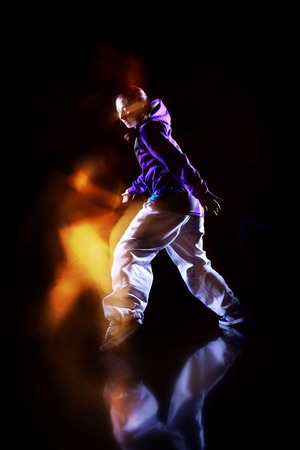 Girl dancer in motion with special light effectの写真素材