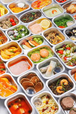 Separate portions of different food into containersの写真素材