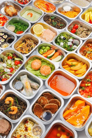 Separate portions of different food into containersの写真素材