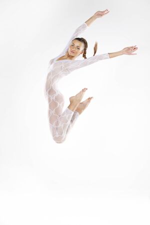 Pretty young dancer isolated on white studio shotの写真素材