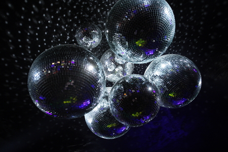 Shiny disco balls on a dark backgroundの写真素材