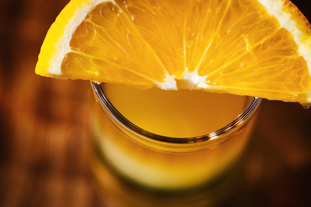 Drink shots and a slice of fresh fruitの写真素材