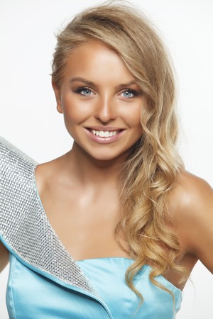 Blonde model in blue dress on white backgroundの写真素材