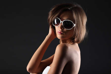 Beautiful girl on black background in white dressの写真素材