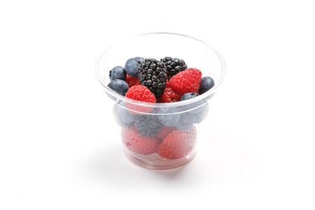 Berries in a cup. Isolated on white. Studio shot.の写真素材