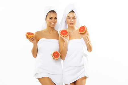 Two happy teen girl after shower playing with grapefruitの写真素材