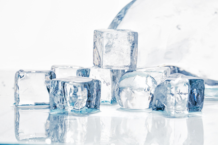 Ice cubes and balls on a wet tableの写真素材