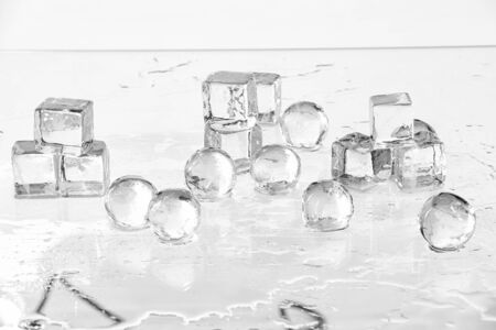 Ice cubes and balls on a wet tableの写真素材