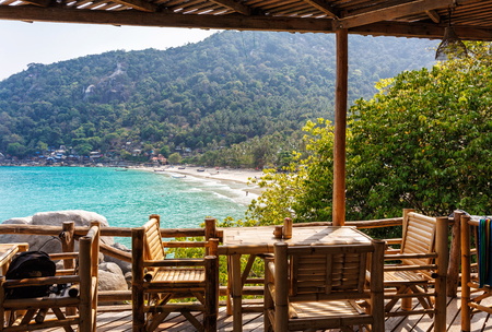 Bamboo tables and chairs on the terrace on a sunny dayの写真素材