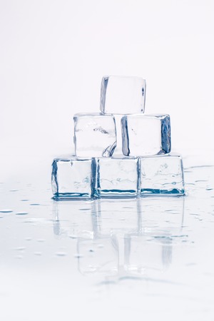 Ice cubes on a wet table studio shotの写真素材