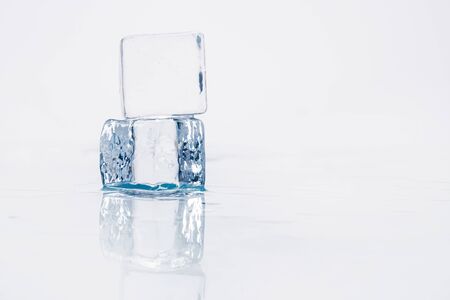 Ice cube on a wet table studio shotの写真素材