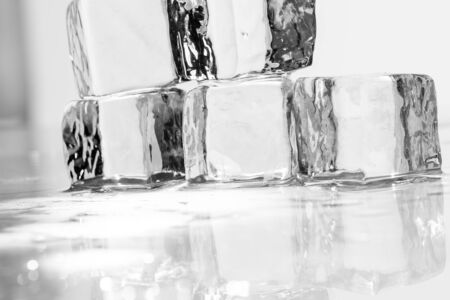 Ice cube on a wet table studio shotの写真素材