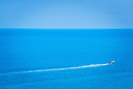 The lonely boat in crystal clear ocean