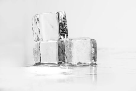 Ice cube on a wet table studio shotの写真素材