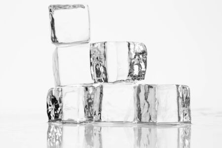 Ice cube on a wet table studio shotの写真素材