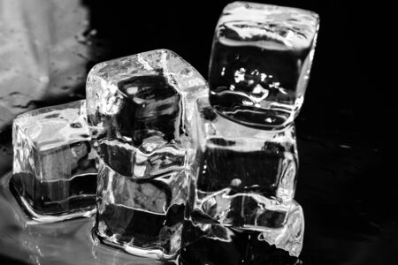 Ice cubes on a wet table studio shotの写真素材