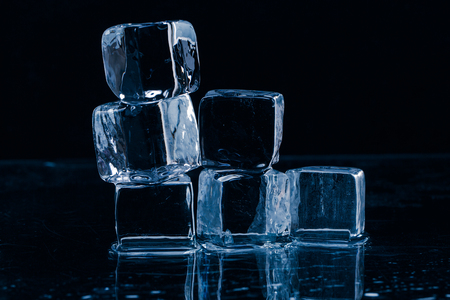 Ice cubes on a wet table studio shotの写真素材