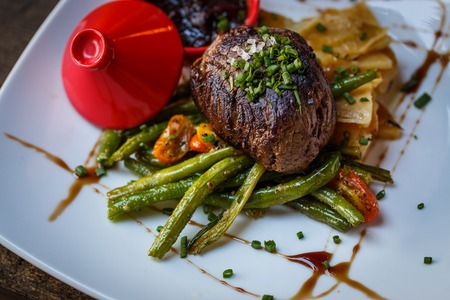 Beef fillet mignon with asparagus on a white plateの写真素材