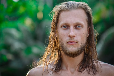 Portrait of a handsome man with long blond hair