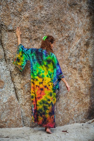 Attractive woman in summer clothes on brown rock backgroundの写真素材