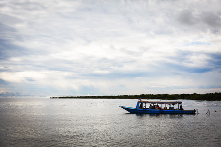 Boat in the calm sea in Cambodiaの写真素材