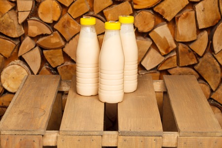 3 bottles of milk on a wooden standの写真素材