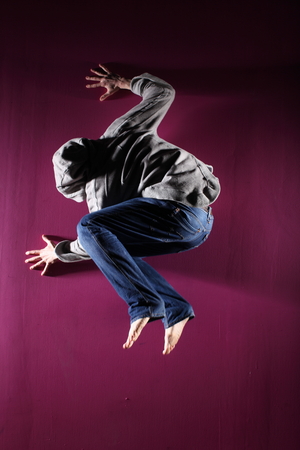Man in motion on pink background studio shotの写真素材