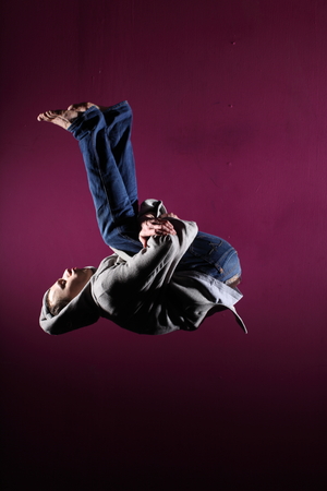 Man in motion on pink background studio shotの写真素材