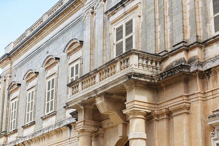 Balconies in Malta on the stone facade of historical townhousesの写真素材
