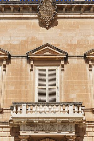 Balconies in Malta on the stone facade of historical townhousesの写真素材