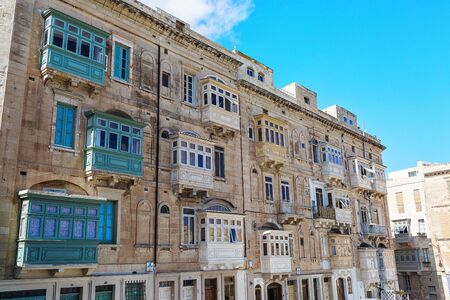 Balconies in Malta on the stone facade of historical townhousesの写真素材