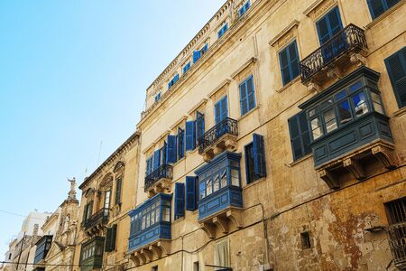 Balconies in Malta on the stone facade of historical townhousesの写真素材