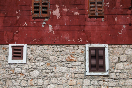 Grunge textured old wall with brown shuttersの写真素材