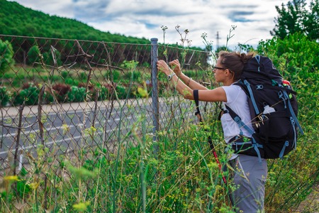 Girl trekker in campaign with a backpackの写真素材