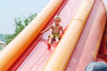 Boy on a water slideの写真素材