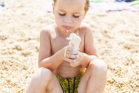 Boy eating ice creamの写真素材