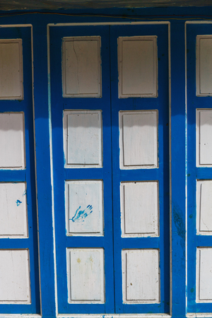 Old textured wooden white and blue doorの写真素材