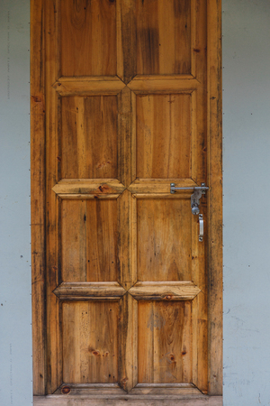 Old textured wooden brown door with a lockの写真素材