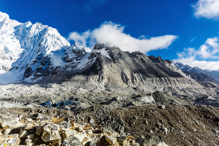 The peak of the snowy mountains in the cloudsの写真素材