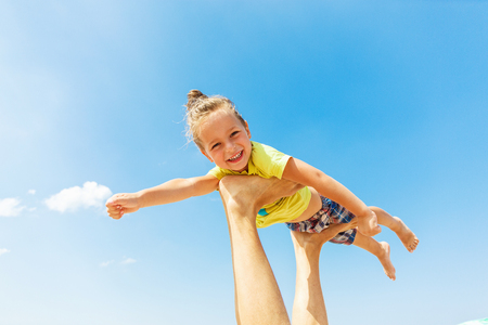 Flying boy like super hero on the blue sky backgroundの写真素材