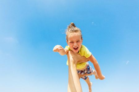 Flying boy like super hero on the blue sky backgroundの写真素材
