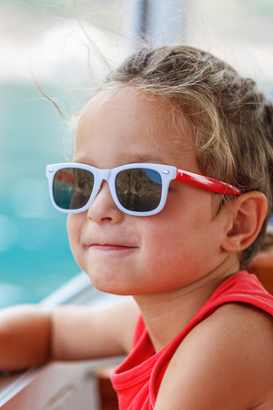 Portrait of a beautiful boy in sunglasses and capの写真素材