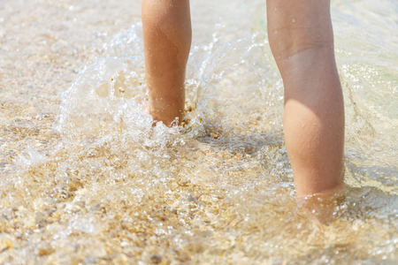 Little feet walking in the blue seaの写真素材