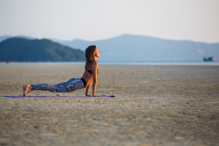 Beautiful girl practicing yogaの写真素材