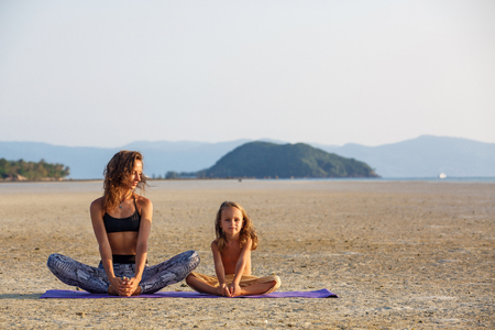 Mother with her son doing yogaの写真素材