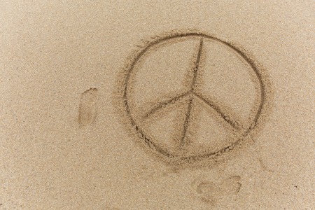 Peace sign on the sandの写真素材