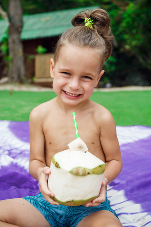 boy drinking coconutの写真素材