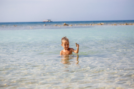 little boy in the sea in Thailandの写真素材
