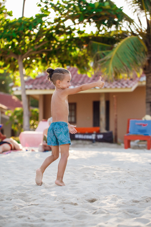 Boy playing flying disk on the beachの写真素材