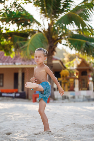 Boy playing flying disk on the beachの写真素材